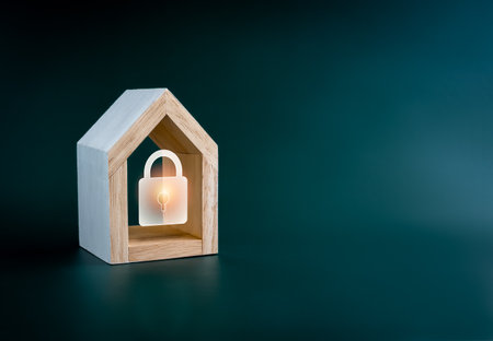 Digital lock icon glowing in simple miniature wooden house isolated on green background with copy space. Smart Home security, home insurance, real estate and property protection, home secure concept.の写真素材