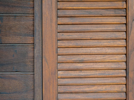 Wooden window with brown shutters background. Close-up pattern texture of traditional asian style wood work, window and wall backgrounds.の写真素材