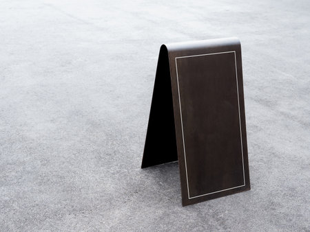 Mockup white rectangle frame with empty space on street tent floor sign, outdoor on the ground in front of cafe. Black blank iron frame for information on signage on grunge cement floor background.の写真素材