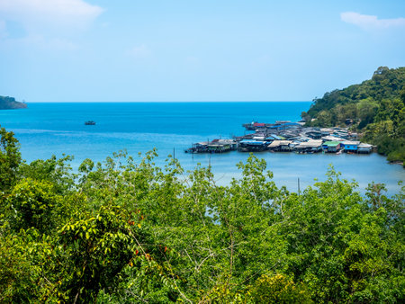 Ao Yai village, Koh kood, trat, Thailand. Scene of fisherman local village with many house in the tropical blue sea and green mountain with beautiful view with open sky on summer sunshine day.の写真素材