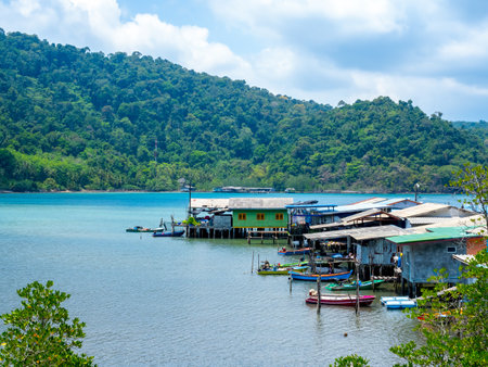 Ao Yai village, Koh kood, trat, Thailand. Scene of fisherman local village with many house in the tropical blue sea and green mountain with beautiful view with open sky on summer sunshine day.の写真素材