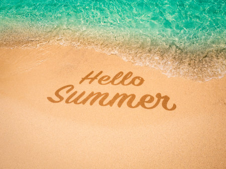 Hello summer concept. Relaxing calligraphy font of "HELLO SUMMER", hand draw on clean sandy beach with tropical seaside, clear aqua water, sea surf wave background. Holiday vacation photo banner.の写真素材