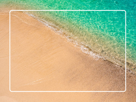 White line frame on calm beach scene, movement of blue sea water and wave surf on clean sandy beach ocean, sea shore, coastline, summer vacation holiday poster background.の写真素材
