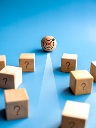 Wood sphere, leader with target icon with forward arrow in front of the wooden cube blocks with problem on blue background. Concept of leadership, business target and success, motivation and solution.の写真素材