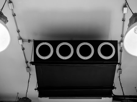 Black machine, modern air conditioning ceiling mounted ventilation system decoration on ceiling near electrical wiring steel pipes in old white construction building factory, loft style interior.の写真素材