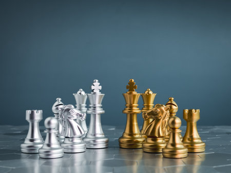 Set of golden and silver chess pieces element, king, queen rook, bishop, knight, pawn standing on hexagon pattern chessboard on blue background. Competition, game, war, emulation and planning concept.の写真素材