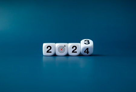 2024 happy new year with the goal and successful concepts. Flipping the 2023 to 2024 year numbers calendar with goal target icon on white dice, cube blocks isolated on dark blue  banner background.の写真素材