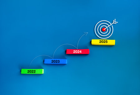 Curved line arrow rising jump step up the multicolor stair blocks from 2022 to 2025 with  target icon on the top block on blue background. Business goal and success, growth marketing, trends concepts.の写真素材