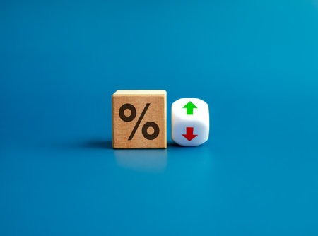 Percentage icon on wooden cube block and up and down arrow symbol on flipping white dice on blue background. Interest rate, financial stocks, ranking, GDP percent change, money exchange concepts.の写真素材