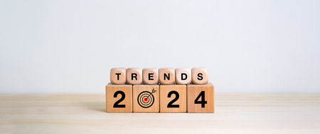 2024 trends concept. text trends and 2024 year number on wooden cube blocks stacked isolated on wood...