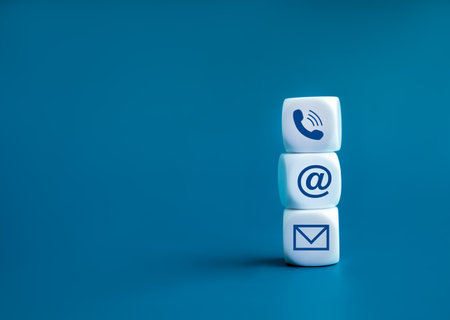 Contact us concept. Company website, FAQ, hotline phone number call, address and e-mail marketing for customer support . Contact us icons on wooden cube block stack on blue background with copy space.の写真素材