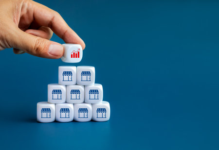 Business goal and success concept. Growth graph icon cube block in hand, put on the top of white...