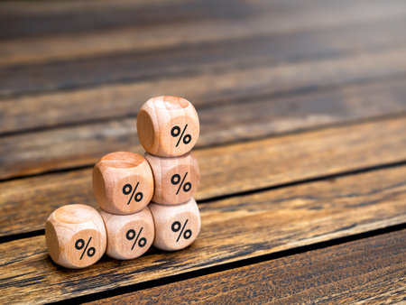Percentage icon on wooden cube blocks build as business chart steps on wood table background with copy space. Business growth graph process, interest rate finance and mortgage rates concepts.の写真素材