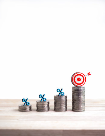 3D Target icon and blue percentage symbol on coin stacked as a bar graph chart steps isolated on white background. Investment, profit, income, savings, business growth, economic improvement concepts.の写真素材