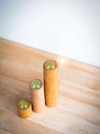 Green quality guarantee award icon on round wooden sticks as business graph steps with rise arrow on...