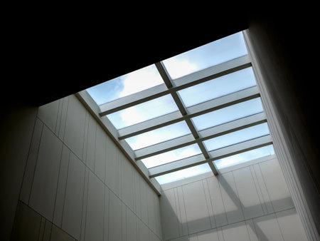 Ant eyes view of ceiling window glass roof decorating the modern building's interior, to add the...