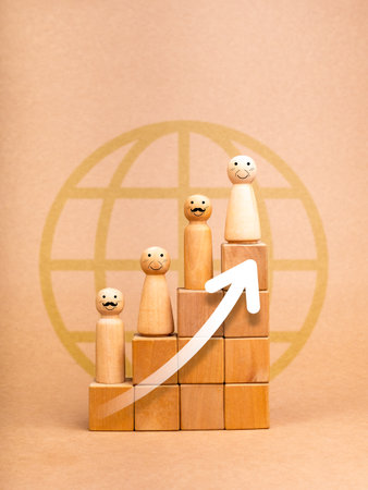 Population and aging, The growing elderly population concepts. Rising up white arrows on wooden cube block graph steps with old people face, wooden figures on brown background with globe earth symbol.の写真素材