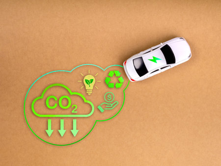 EV car, Electric energy battery charge vehicle with sustainable development concept. Top view of white toy car with power energy icon, Co2 emissions, recycle and save money symbol on beige background.の写真素材