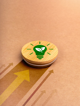 Green power energy icon with lightbulb and leaf symbol on round wood badge moving fast with heading arrows on brown recycled paper background. Eco-Minded entrepreneurs running green business concept.の写真素材
