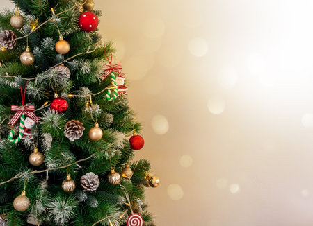 Merry Christmas and Happy New Year concept. Close-up Christmas tree decorated with lighting, pine cones, santa claus, red and gold ball, festive party ornament on white background with copy space.の写真素材
