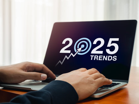 Happy new year 2025 with business trends concept. 2025 calendar number with Target icon on laptop computer screen while businessman searching online. Digital marketing and e-commerce research concept.の写真素材