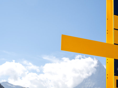 A yellow outdoor signpost directions pole with empty space for text and icon. Blank modern direction sign panels on blue sky and cloud background with copy space.の写真素材