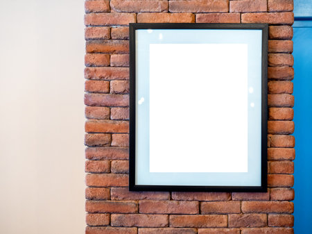 Mockup vertical black artist frame or white blank poster on red brick wall background inside the building loft style. The blank billboards attached to a buildings exterior brick wall.の写真素材