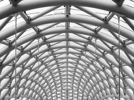 Curved construction on the arch ceiling of the bridge of peace, Tbilisi, modern architecture in...