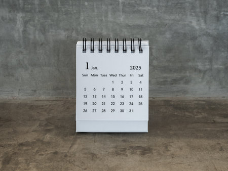 January 2025 page of desk calendar for organizer to plan and reminder, standing on grunge concrete table background, loft style. White small table calendar with the first month, Happy new year 2025.の写真素材