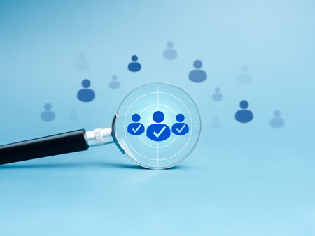 Business digital marketing, target audience and customer, HR human resources, teamwork management concepts. People group icon, hit target in magnifying glass lens on blue background, minimal style.の写真素材