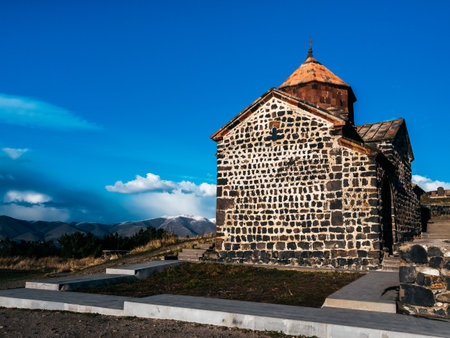 Scene of the ancient buildings Sevanavank Monastery on hill, blue sky background. Historical churches and cathedrals at the northwestern shore of Lake Sevan in the Gegharkunik Province of Armenia.の写真素材