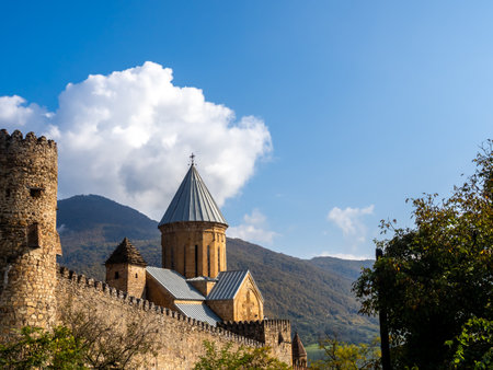 Ananuri Fortress, on mountains and blue sky background, historic landmark located in the Ananuri village with castle complex that consists of two churches, popular tourist destination in Georgia.の写真素材