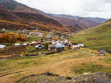 View from the hill, the Ushguli village, UNESCO heritage with many  houses near the mountains and autumn landscape, tourist attraction in the Svaneti region, Georgia.の写真素材