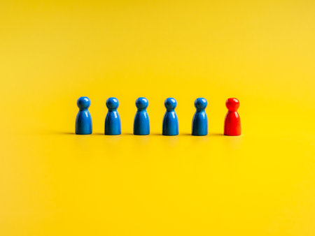 The red one, different standing out of the group of blue peg dolls, people symbols, on yellow...