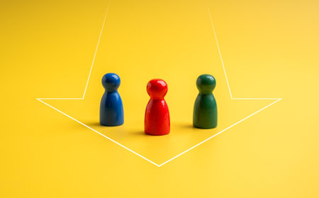 The red, green and blue, different colors of peg dolls standing together in heading arrow shape on...