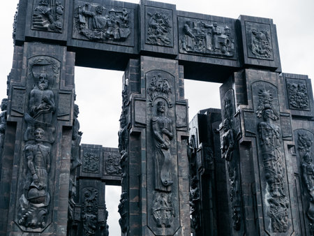 Chronicles of Georgia, monument history, design detail on black sculpture pillars, famous tourist attraction, located on Keeni hill near the Tbilisi sea, Georgia, with white fog sky after rain day.の写真素材