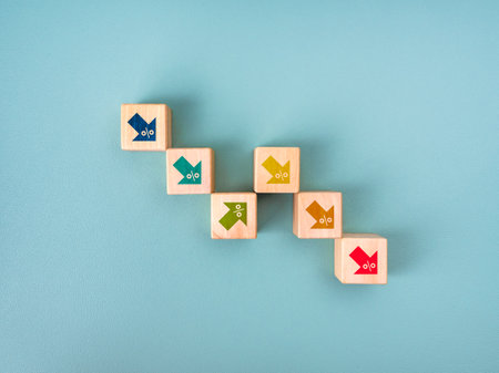 Multi colors up and down arrows with percentage icon on wooden cube blocks as fluctuating graph...