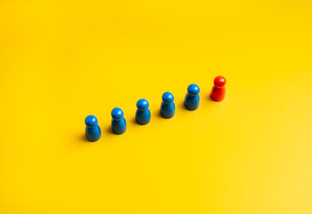 The red one, different, stand lead of the group of blue peg dolls, people symbols, on yellow...