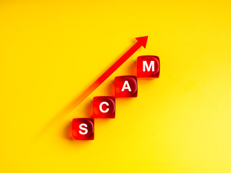 Scam growth concept, growing scams, fraud and cybercrime rise globally. Rise up arrow on text "SCAM" on four red dices arrange as growth graph steps, isolated on yellow background, minimalist.の写真素材