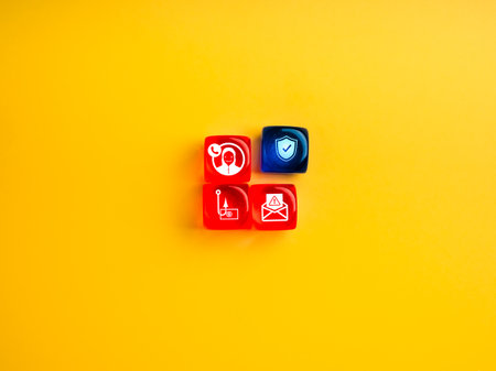 Scam protection concept, online phishing and financial fraud, scam calls, cybercrime. Safety shield icon on blue dice one near three red dices group with scammer tactics symbols, on yellow background.の写真素材