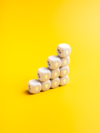 Business growth graph process and economic improvement concepts. Percentage icons and up arrow signs on white dice cube blocks as business growth graph steps isolated on yellow vertical background.の写真素材