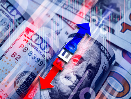 Text "FED" with up and down arrows, percentage icon and stock chart overlay over 100 US dollar bills background. interest rate increase and decrease, funds target range, economy system concept.の写真素材