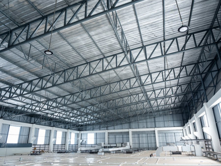 Wide angle scene of warehouse construction buildings roof structure with windows and air ventilation system on warehouse storage ceiling with sunlight. Inside industrial factory roofing, background.の写真素材