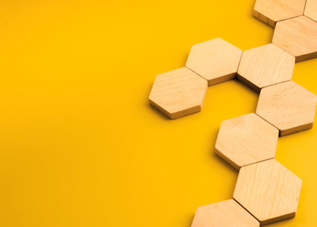 Blank wooden hexagon blocks, for icons or infographics design arranged in network pattern on yellow...