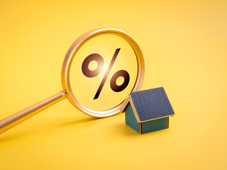 Real estate concept with magnifying glass showing percentage sign and small house model on yellow background, symbolizing property tax, mortgage interest, housing loan, and home investment analysis.の写真素材