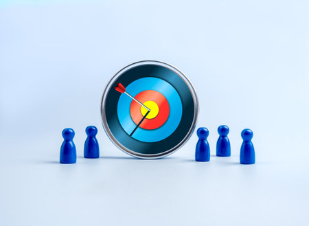 Big modern target board with an arrow hitting the center surrounded by blue team figures, symbolizing stakeholder alignment, shared goals, tech team focus, business objectives, and teamwork strategy.の写真素材