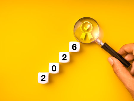 Success plan 2026 new year concept with cubes forming staircase and magnifying glass highlighting...