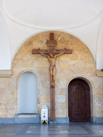 Wooden crucifix of Jesus inside Holy Trinity Cathedral of Tbilisi, Georgia, symbolizing Christian faith, Orthodox devotion, and sacred interior architecture with carved details and spiritual ambiance.の写真素材