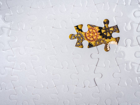 Puzzle piece revealing gears inside as symbol of teamwork, management, and problem solving. Concept for solution, strategy, hidden process, business operation, innovation, and collaborative success.の写真素材