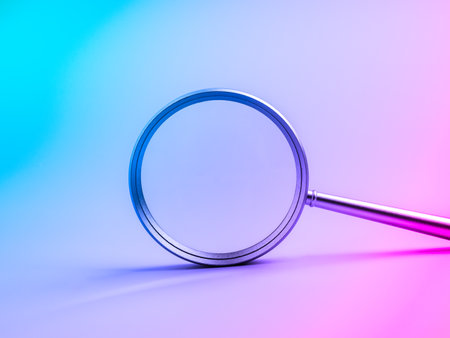 Magnifying glass on futuristic gradient background symbolizing searching tool, research, discovery, technology trends, analysis, data exploration, and innovation for modern digital business concepts.の写真素材